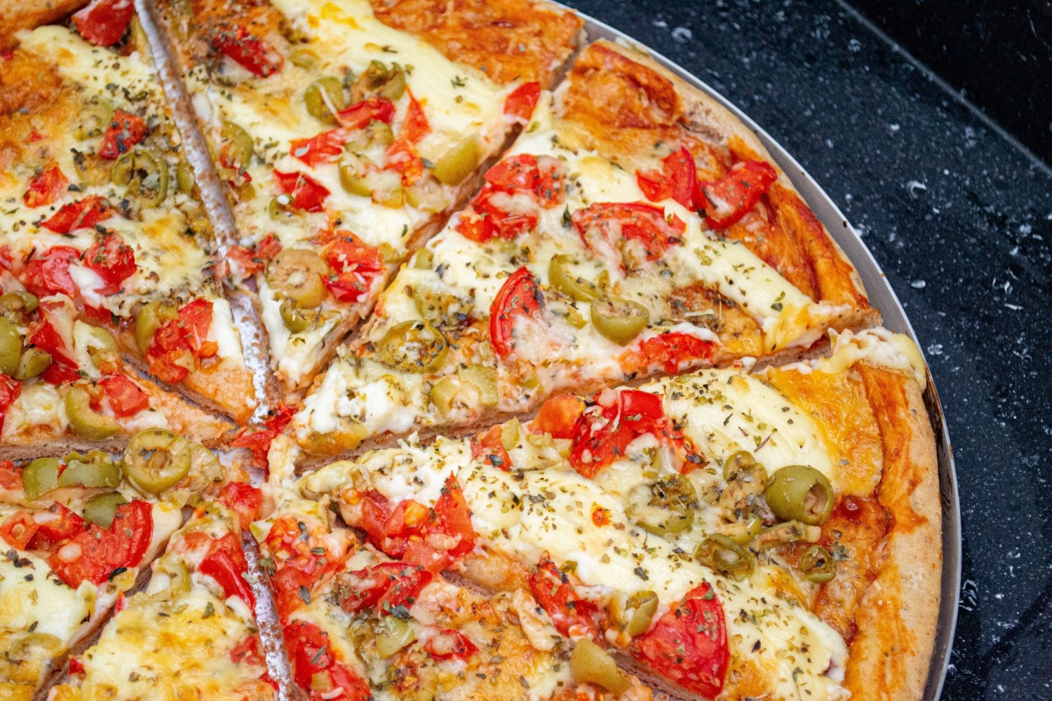 Pizza with Smoked Scamorza Cheese, Sundried Tomatoes and Olives
