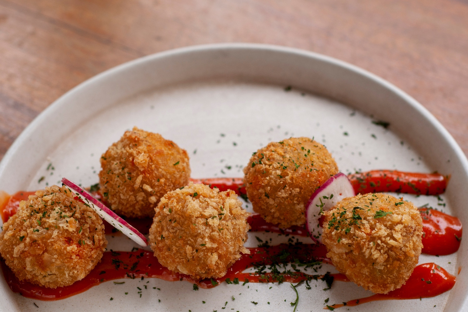 Golden Potato Croquettes with Mint & Pecorino on Silky Red Pepper Cream